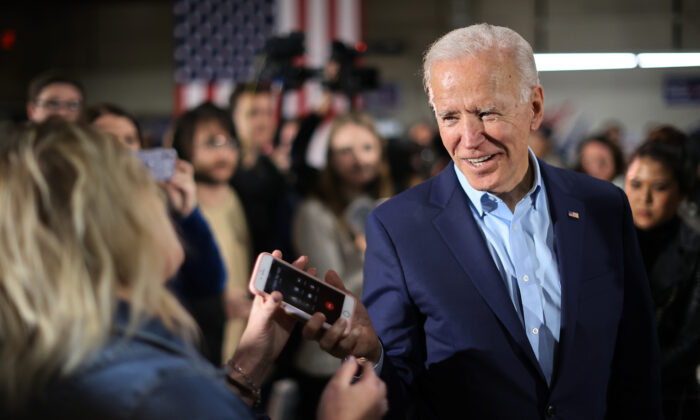 Democratic presidential candidate former Vice President Joe Biden returns a supporter's phone after talking to her relative during a campaign event at the Central Iowa Fairgrounds in Marshalltown, Iowa, on Jan. 26, 2020. (Chip Somodevilla/Getty Images)