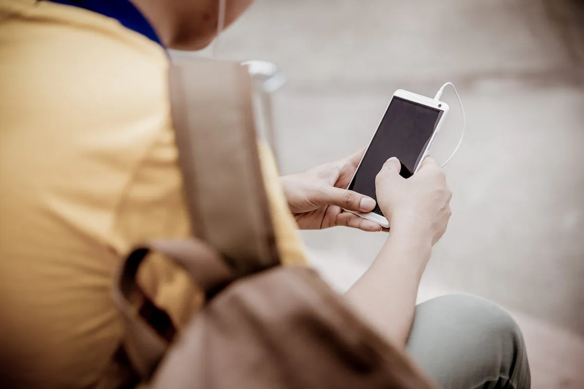 A college student using his cellphone. (Portrait Images Asia/Shutterstock)