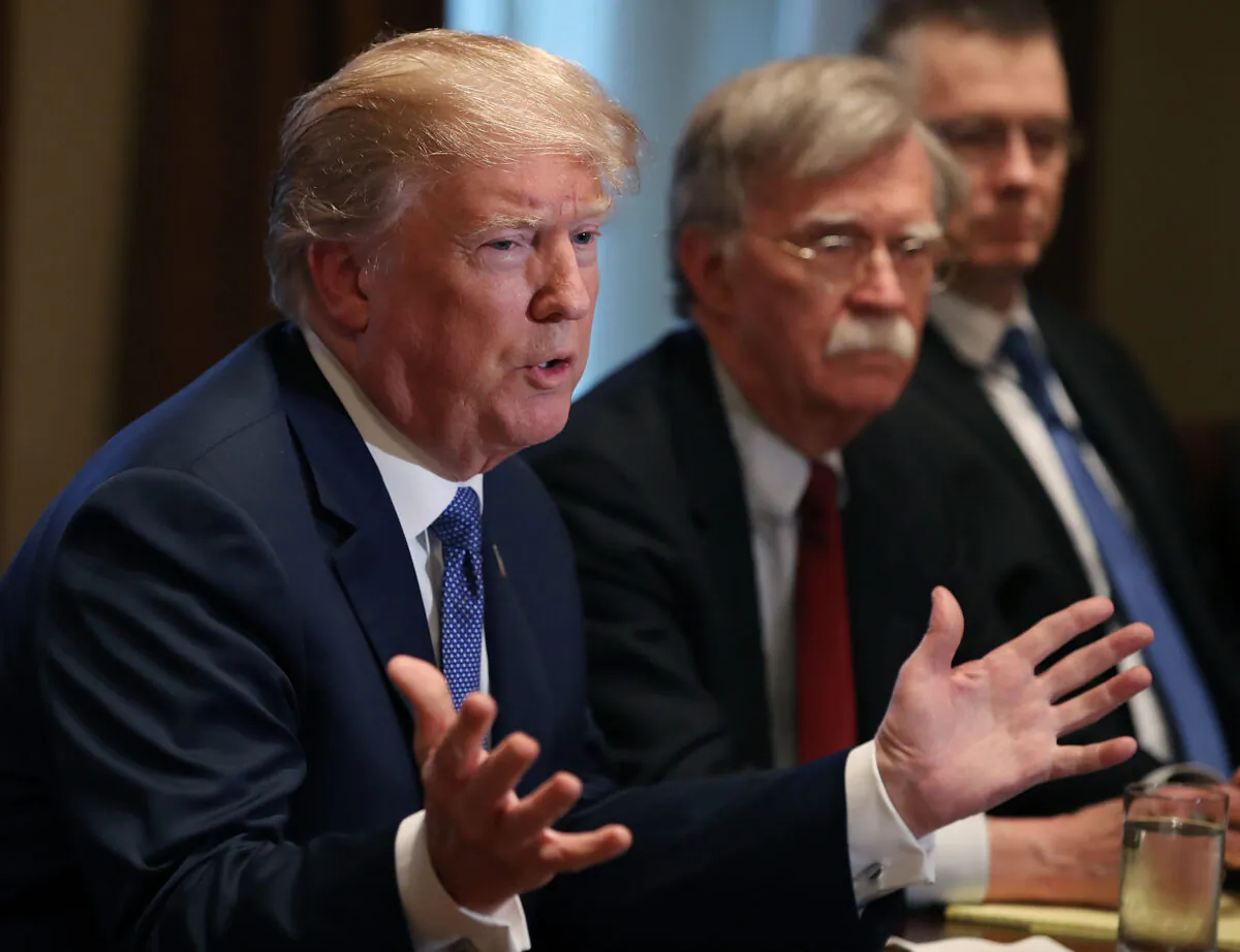 President Donald Trump is flanked by National Security Adviser John Bolton in the Cabinet Room of the White House in Washington on April 9, 2018. (Mark Wilson/Getty Images)