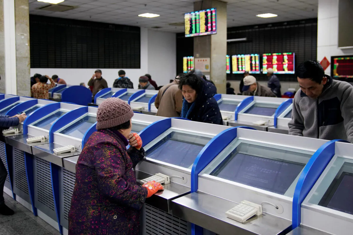 Investors look at computer screens showing stock information at a brokerage house in Shanghai, China on Jan. 16, 2020. (Aly Song/Reuters)