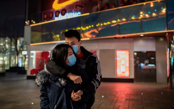A couple hugs at an empty shopping mall