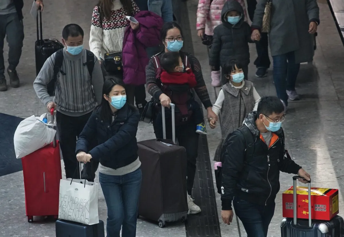 Passengers wear protective face masks arrive at the high speed train station in Hong Kong on Jan. 28, 2020. (Vincent Yu/AP Photo)