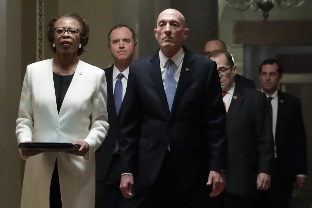 U.S. House Sergeant at Arms Paul Irving and House Clerk Cheryl Johnson, as they lead the seven impeachment managers, including House Intelligence Committee Chairman Rep. Adam Schiff (D-Calif.), House Judiciary Committee Chairman Rep. Jerry Nadler (D-N.Y.), and Rep. Jason Crow (D-Colo.), bring the two impeachment articles to the Senate chamber of the U.S. Capitol in Washington on Jan. 15. 2020. (Alex Wong/Getty Images)