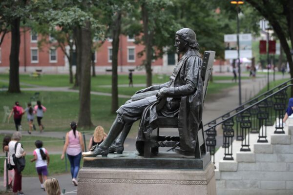 The statue of John Harvard sits in Harvard Yard at Harvard University in Cambridge, Mass., on Aug. 13, 2019. (AP Photo/Charles Krupa)