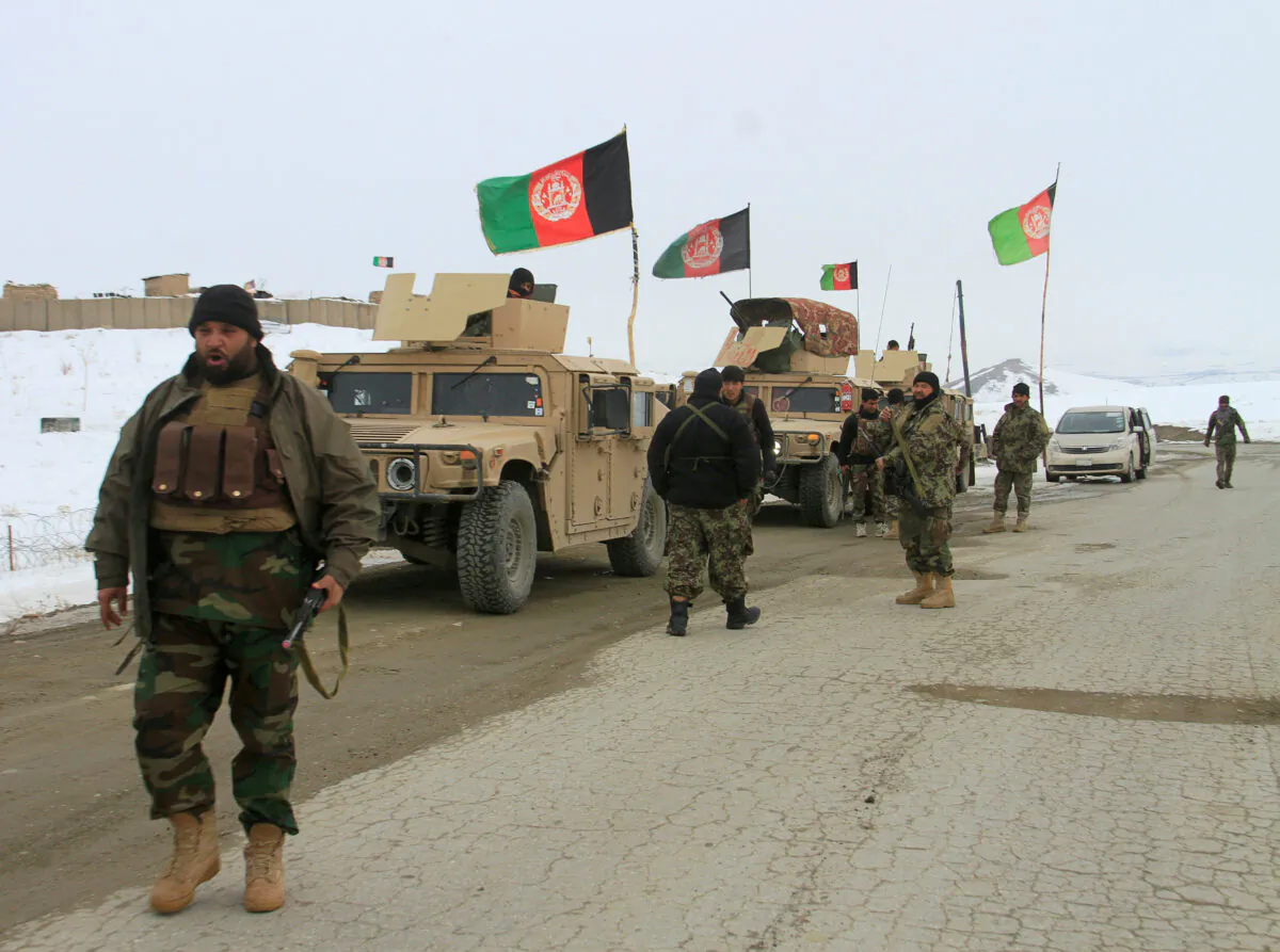 Afghan National Army forces go towards the site of an airplane crash in Deh Yak district of Ghazni province, Afghanistan on Jan. 27, 2020. (Mustafa Andaleb/Reuters-File)