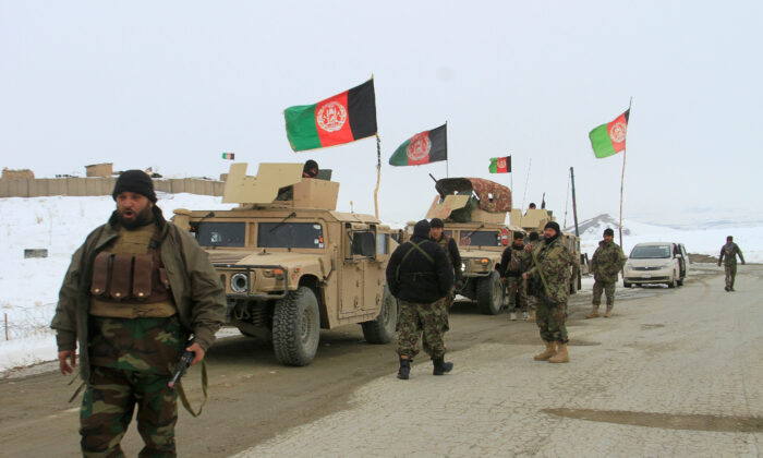 Afghan National Army forces go towards the site of an airplane crash in Deh Yak district of Ghazni province, Afghanistan on Jan. 27, 2020. (Mustafa Andaleb/Reuters-File)
