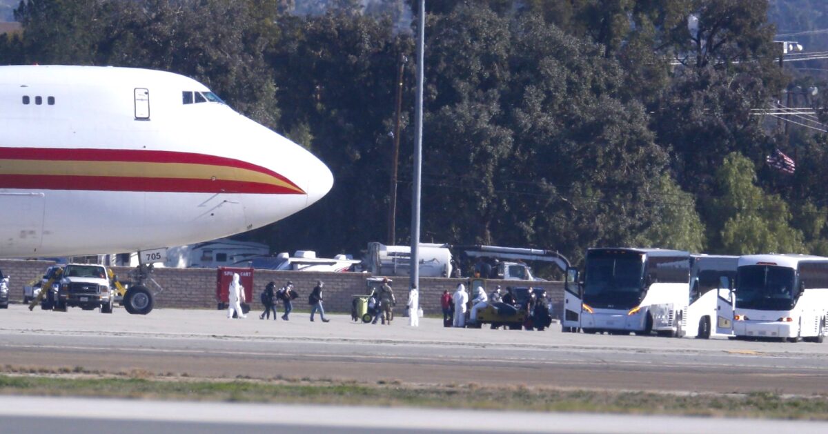 Evacuated Americans get off plane