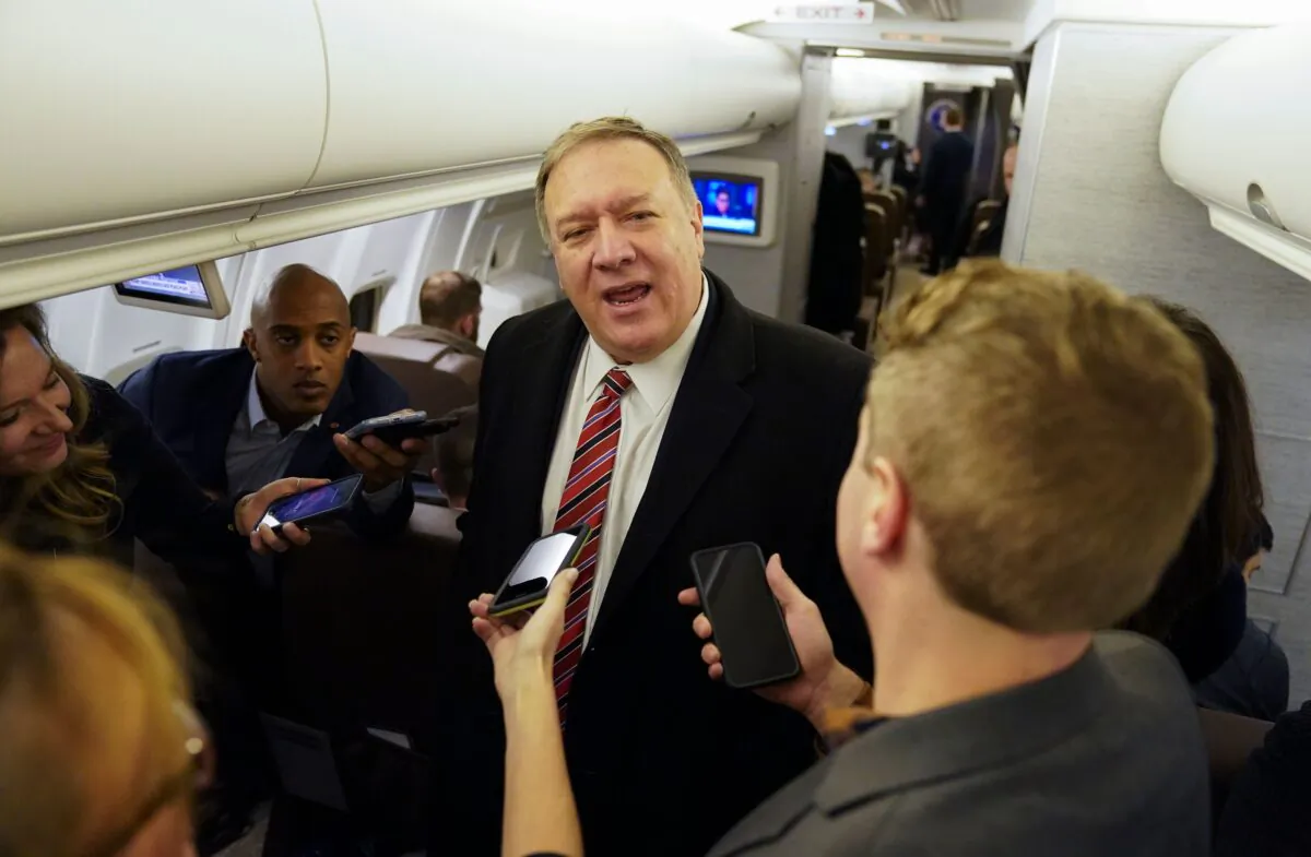Secretary of State Mike Pompeo speaks to reporters aboard his plane en route to London, Britain on Jan. 29, 2020. (KEVIN LAMARQUE/POOL/AFP via Getty Images)