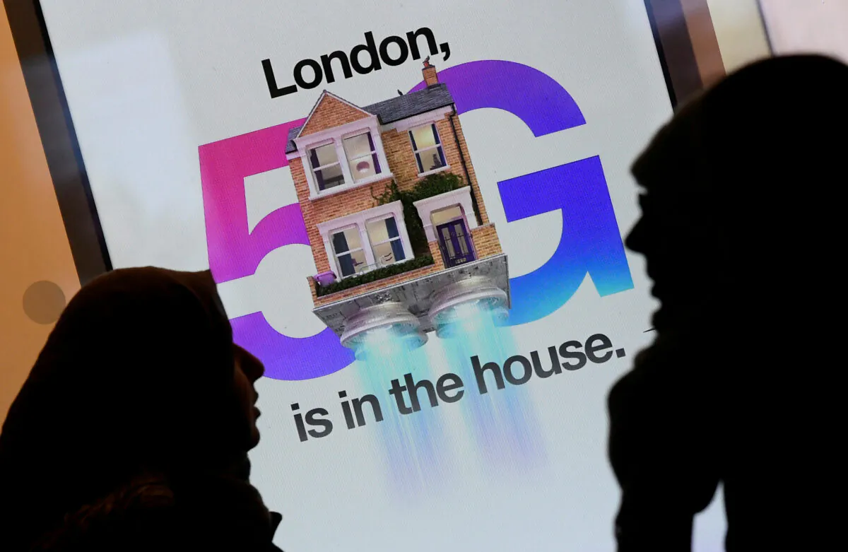Pedestrians walk past an advertisement promoting the 5G data network at a mobile phone store in London, Britain, on Jan. 28, 2020. (Toby Melville/Reuters)