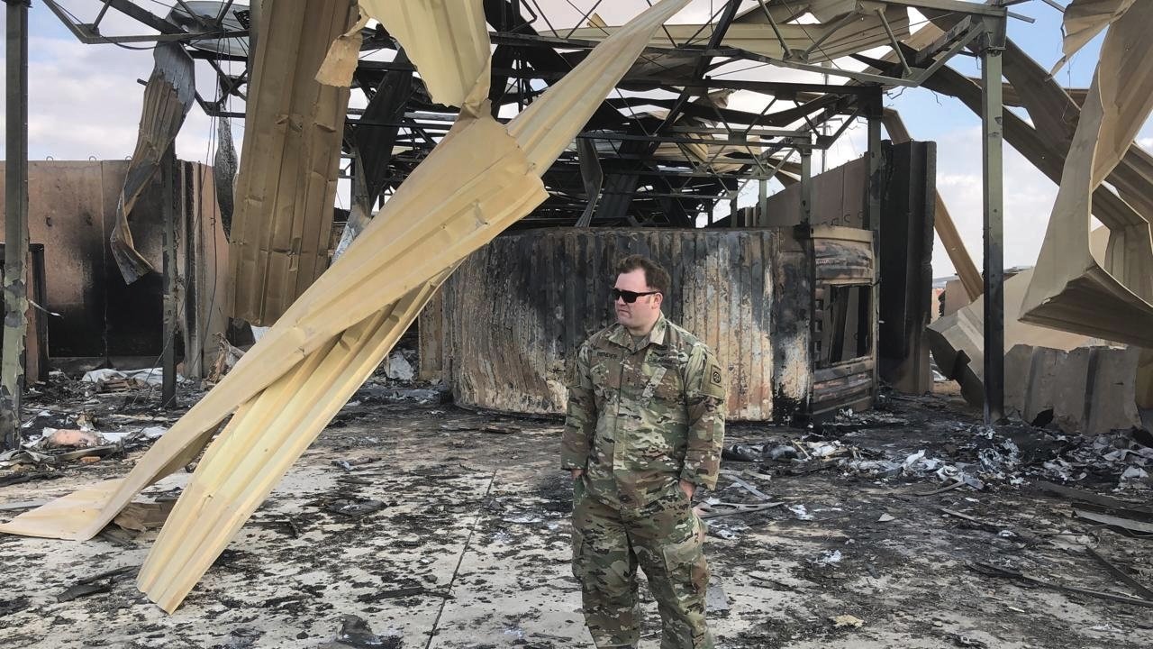 soldier stands at a site of Iranian bombing