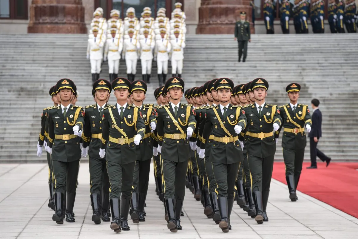 Military honor guards prepare for a welcome ceremony with French President Emmanuel Macron and Chinese leader Xi Jinping at the Great Hall of the People in Beijing on Nov. 6, 2019. (Nicolas Asfouri/AFP via Getty Images)