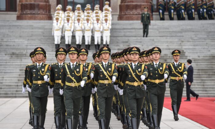 Military honor guards prepare for a welcome ceremony with French President Emmanuel Macron and Chinese leader Xi Jinping at the Great Hall of the People in Beijing on Nov. 6, 2019. (Nicolas Asfouri/AFP via Getty Images)