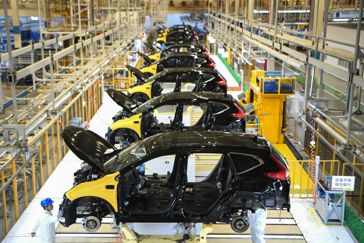 Employees work on an assembly line at the third auto plant of Dongfeng Honda in Wuhan in China's central Hubei Province, on Nov. 17, 2019. (STR/AFP via Getty Images)
