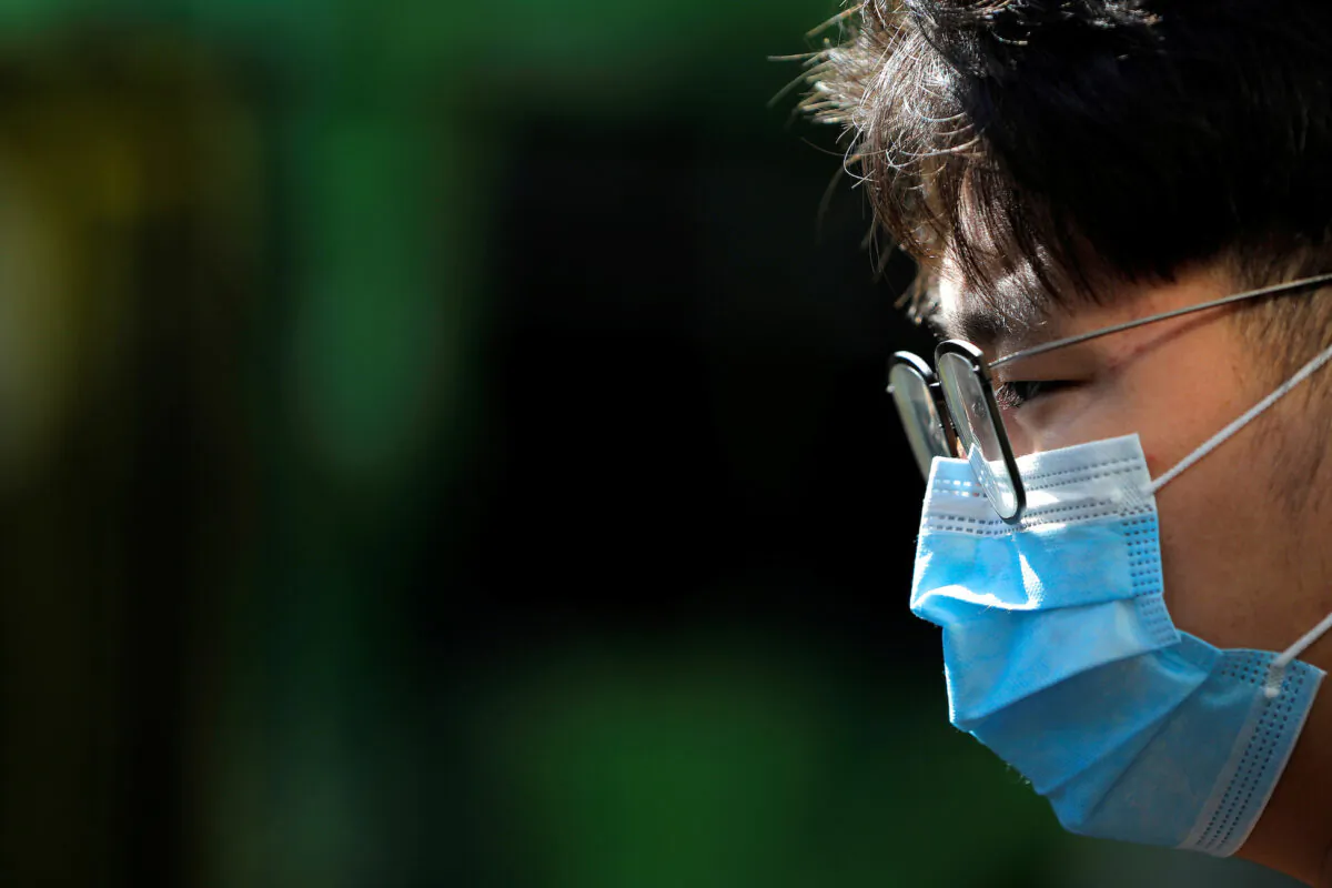 A person wearing a face mask stands on Swanston Street after cases of the coronavirus were confirmed in Melbourne, Australia, on Jan. 29, 2020. (Andrew Kelly/Reuters)