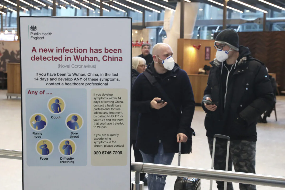 Passengers arrive at Heathrow Airport in London after the last British Airways flight from China touched down in the UK following an announcement that the airline was suspending all flights to and from mainland China with immediate effect amid the escalating coronavirus crisis, on Jan. 29, 2020. Many governments have warned against unnecessary travel to China, as efforts to contain a new and deadly coronavirus virus intensify. (Steve Parsons/PA via AP)