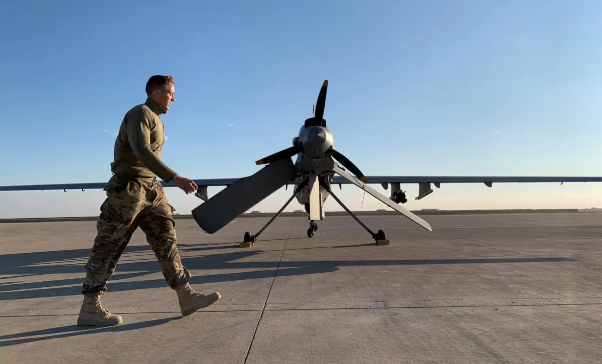 A member the U.S. forces walks past a drone in the Ain al-Asad airbase in the western Iraqi province of Anbar, Iraq, on Jan. 13, 2020. (Ayman Henna/AFP via Getty Images)