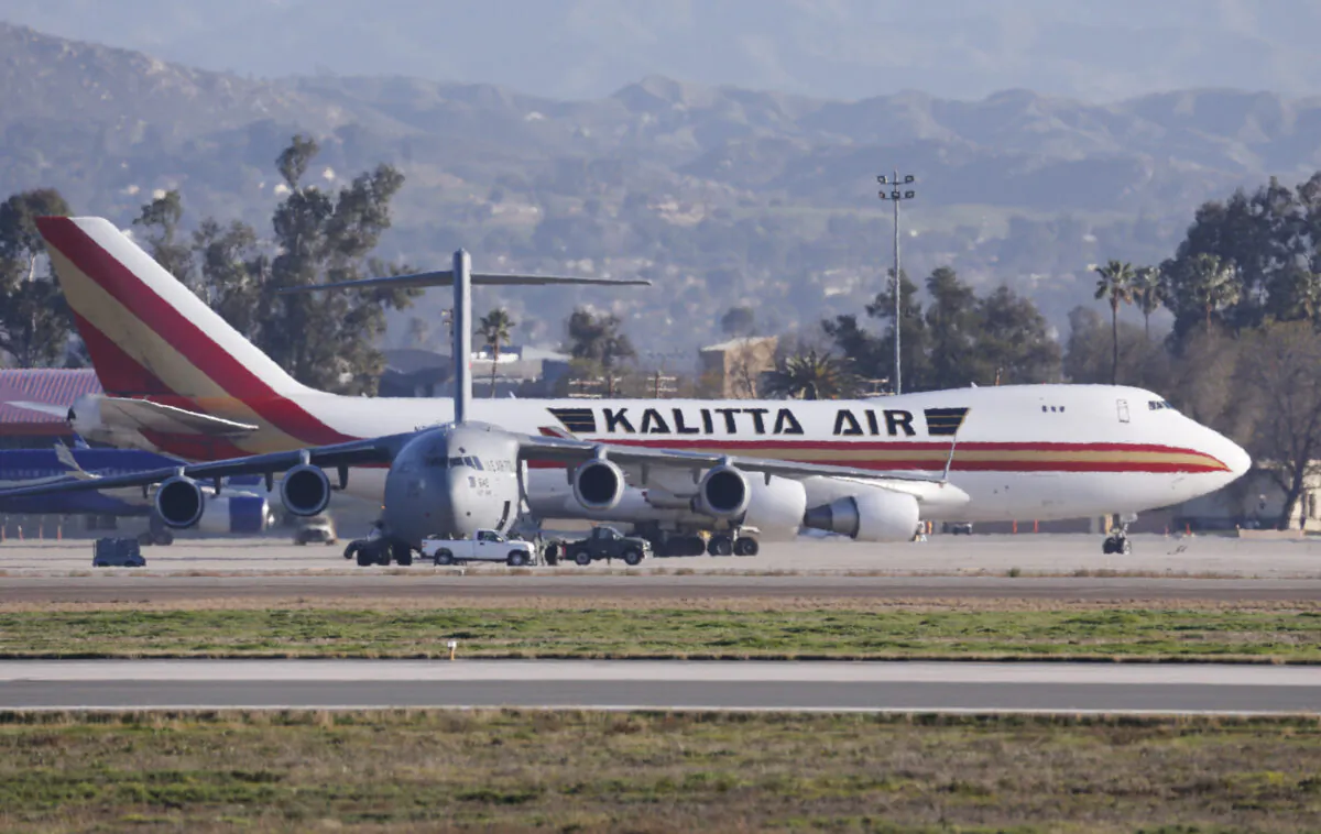 An airplane carrying U.S. citizens being evacuated from Wuhan, China, lands at March Air Reserve Base in Riverside, Calif., on Jan. 29, 2020. (Ringo H.W. Chiu/AP Photo)