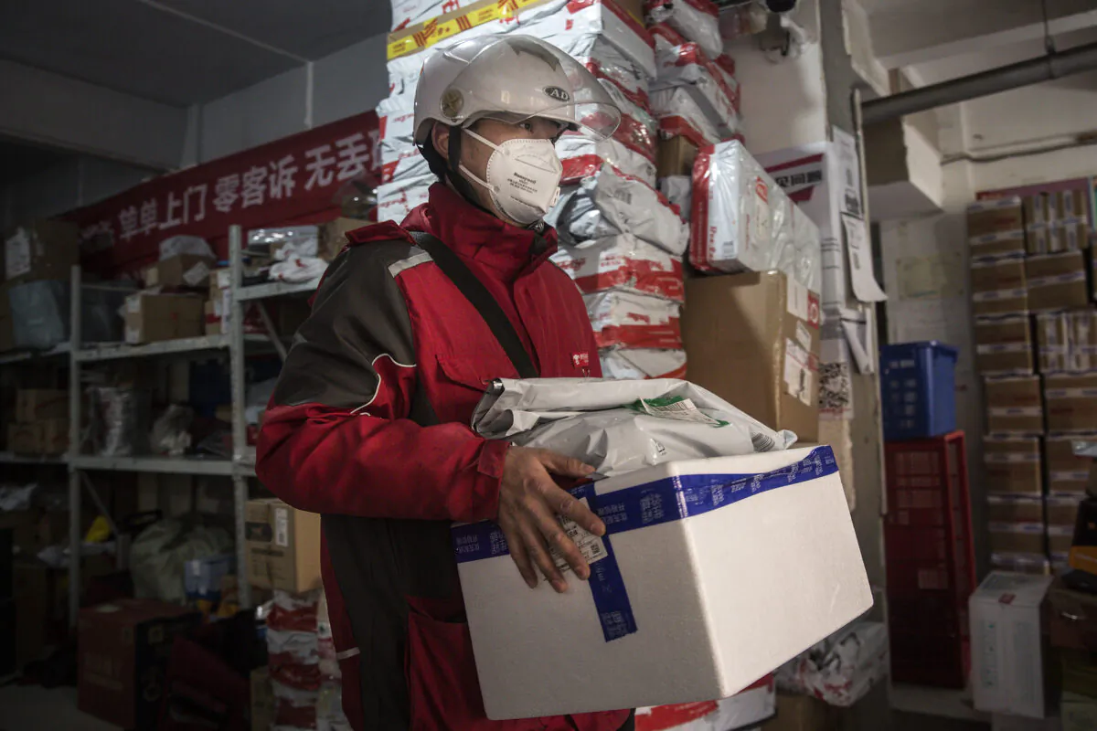 An expressman checks deliveries in an Express station in Wuhan, Hubei Province, China on Jan. 20, 2020. (Stringer/Getty Images)