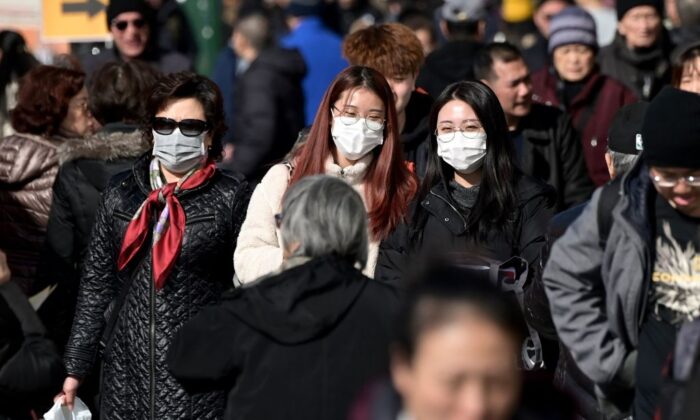 People wear surgical masks in fear of the coronavirus in Flushing, a neighborhood in the New York City borough of Queens on Feb. 3, 2020. (Johannes Eisele/AFP via Getty Images)