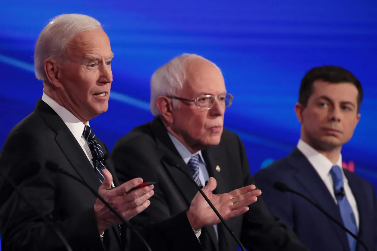Former Vice President Joe Biden, left, speaks next to Sen. Bernie Sanders (I-Vt.) and former South Bend Mayor Pete Buttigieg at the Democratic presidential primary debate in Des Moines, Iowa on Jan. 14, 2020. (Scott Olson/Getty Images)