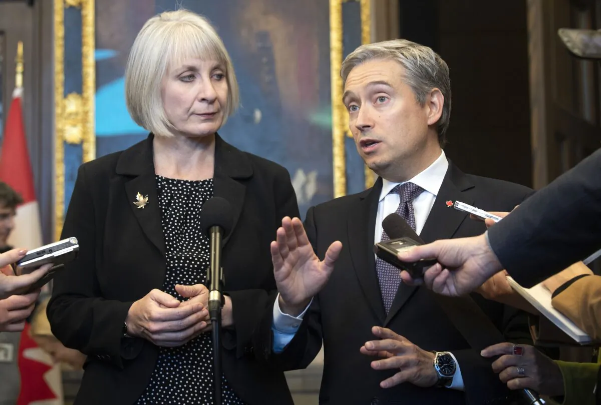 Health Minister Patty Hajdu looks on as Foreign Affairs Minister Francois-Philippe Champagne responds to a question about the coronavirus during a joint press conference in Ottawa on Jan. 29, 2020. (The Canadian Press/Adrian Wyld)