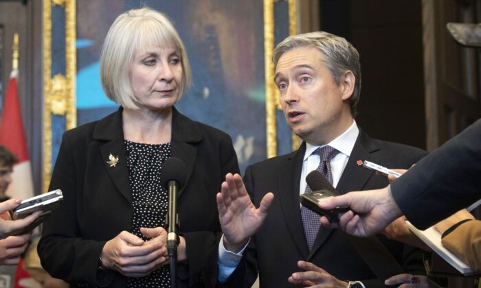 Health Minister Patty Hajdu looks on as Foreign Affairs Minister Francois-Philippe Champagne responds to a question about the coronavirus during a joint press conference in Ottawa on Jan. 29, 2020. (The Canadian Press/Adrian Wyld)