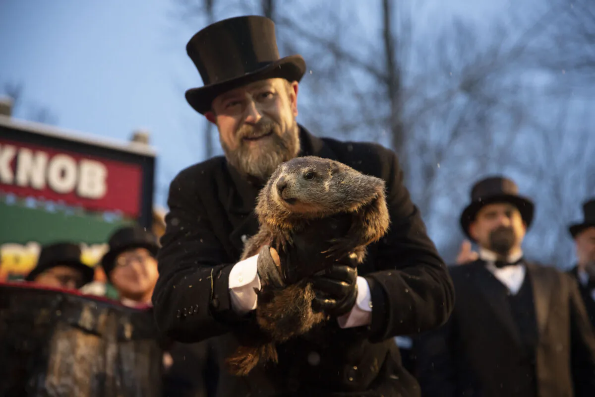 Groundhog Club co-handler Al Dereume holds Punxsutawney Phil, the weather prognosticating groundhog, during the 134th celebration of Groundhog Day on Gobbler's Knob in Punxsutawney, Pa., on Feb. 2, 2020. (Barry Reeger/AP Photo)
