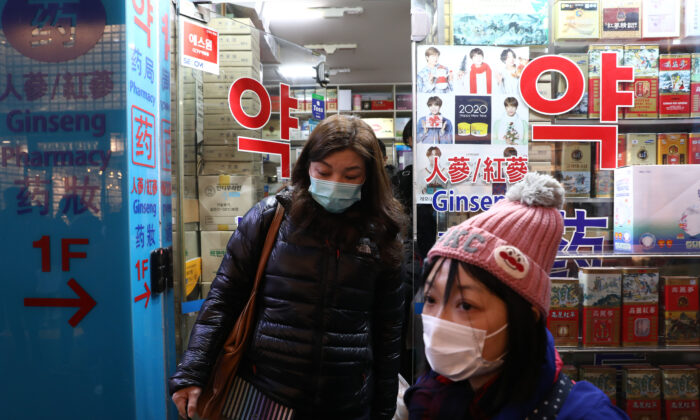 People leave after buying face masks at a pharmacy at Myeongdong shopping district in Seoul, South Korea, on Jan. 31, 2020. (Chung Sung-Jun/Getty Images)