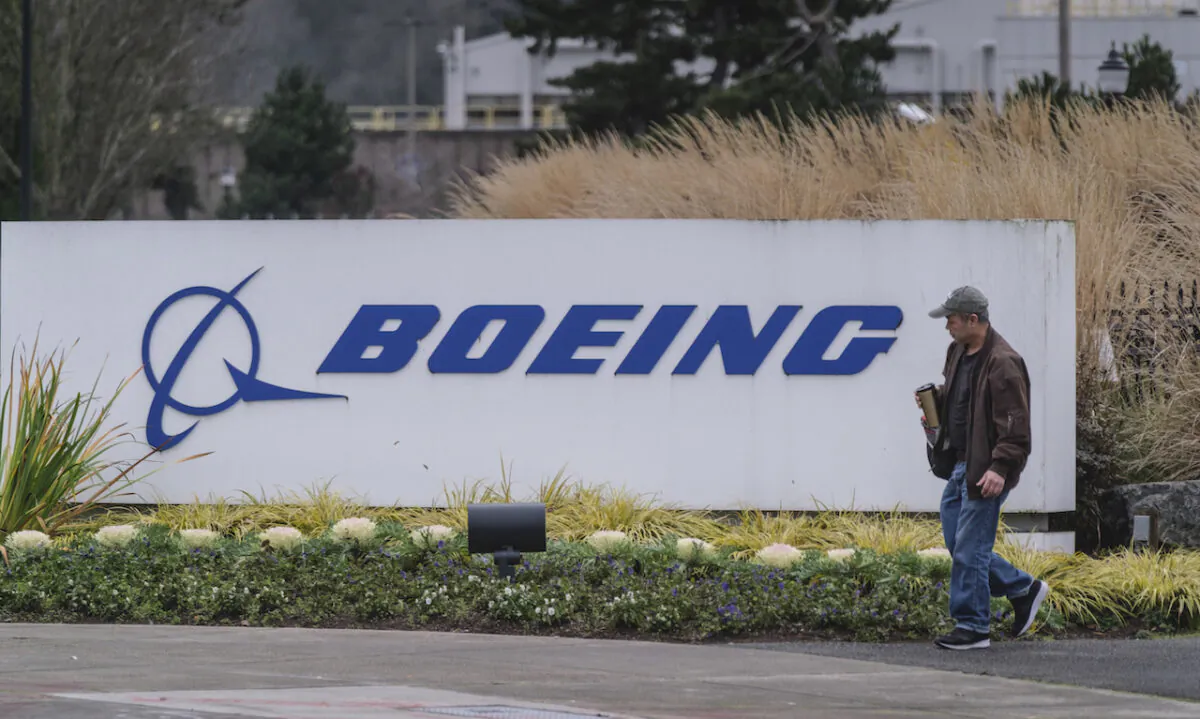 A worker leaves the Boeing 737 factory in Renton, Washington, on Dec. 16, 2019. The company announced it is suspending production of the plane, which has been grounded since early 2019 after two crashes, in January 2020. (Stephen Brashear/Getty Images)