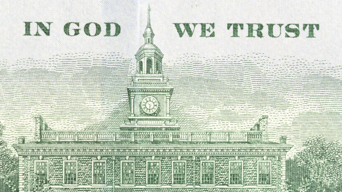 The back of a 100 dollar banknote that features the national motto "In God We Trust." (Shutterstock)