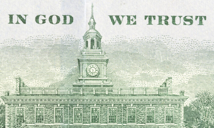 The back of a 100 dollar banknote that features the national motto "In God We Trust." (Shutterstock)