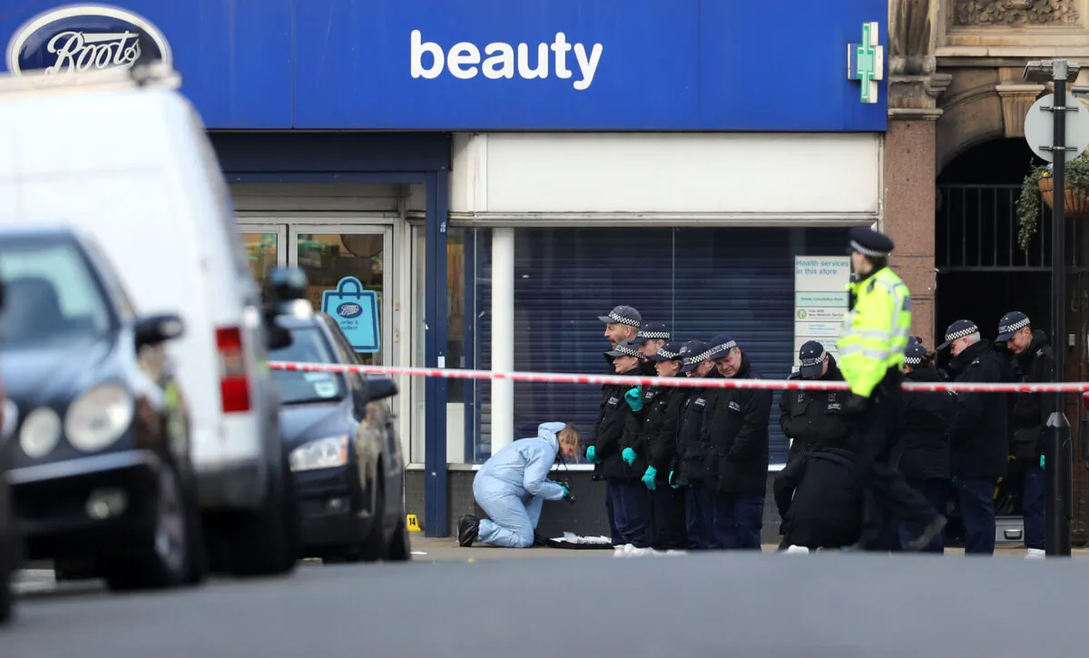 Police officers and forensic officer are seen near the site where a man was shot by armed officers in Streatham, south London, Britain, on Feb. 3, 2020. (Antonio Bronic/Reuters)