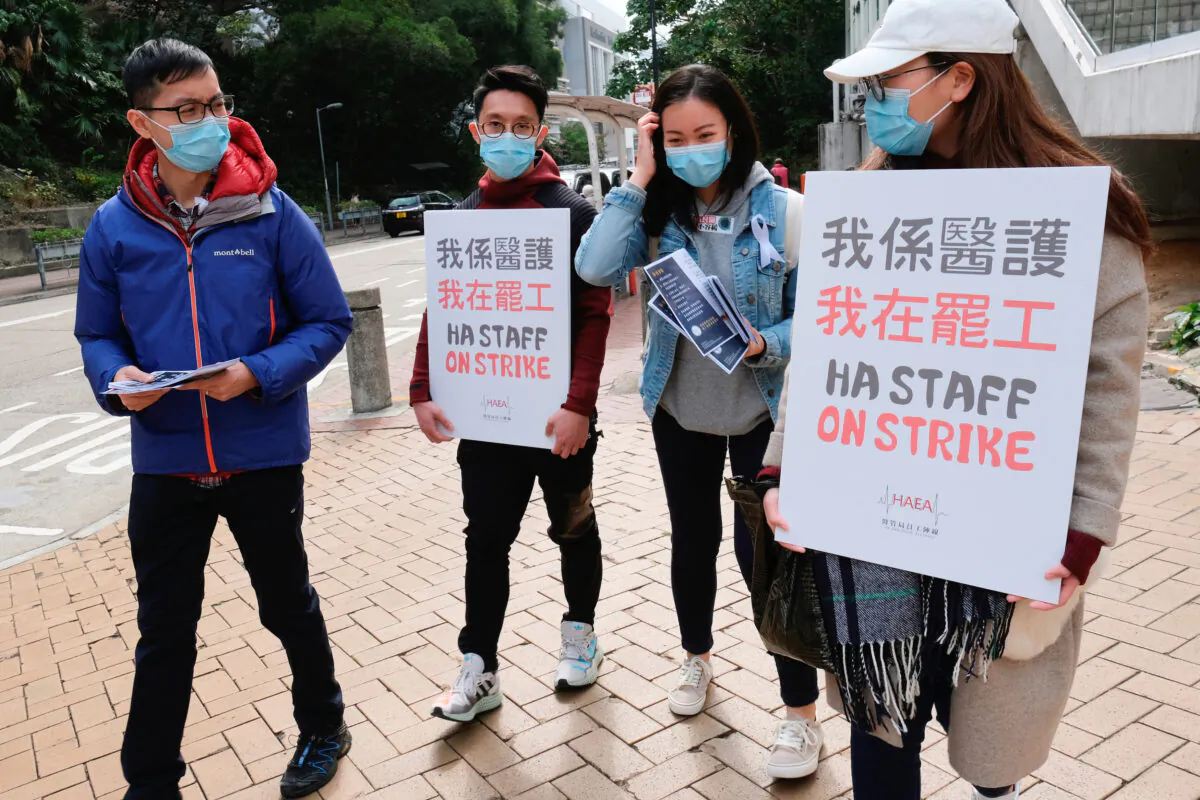 Medical workers hold a strike near Queen Elizabeth Hospital as they demand Hong Kong close its border with China to reduce the coronavirus spreading, in Hong Kong, China, on Feb. 3, 2020. (Tyrone Siu/Reuters)