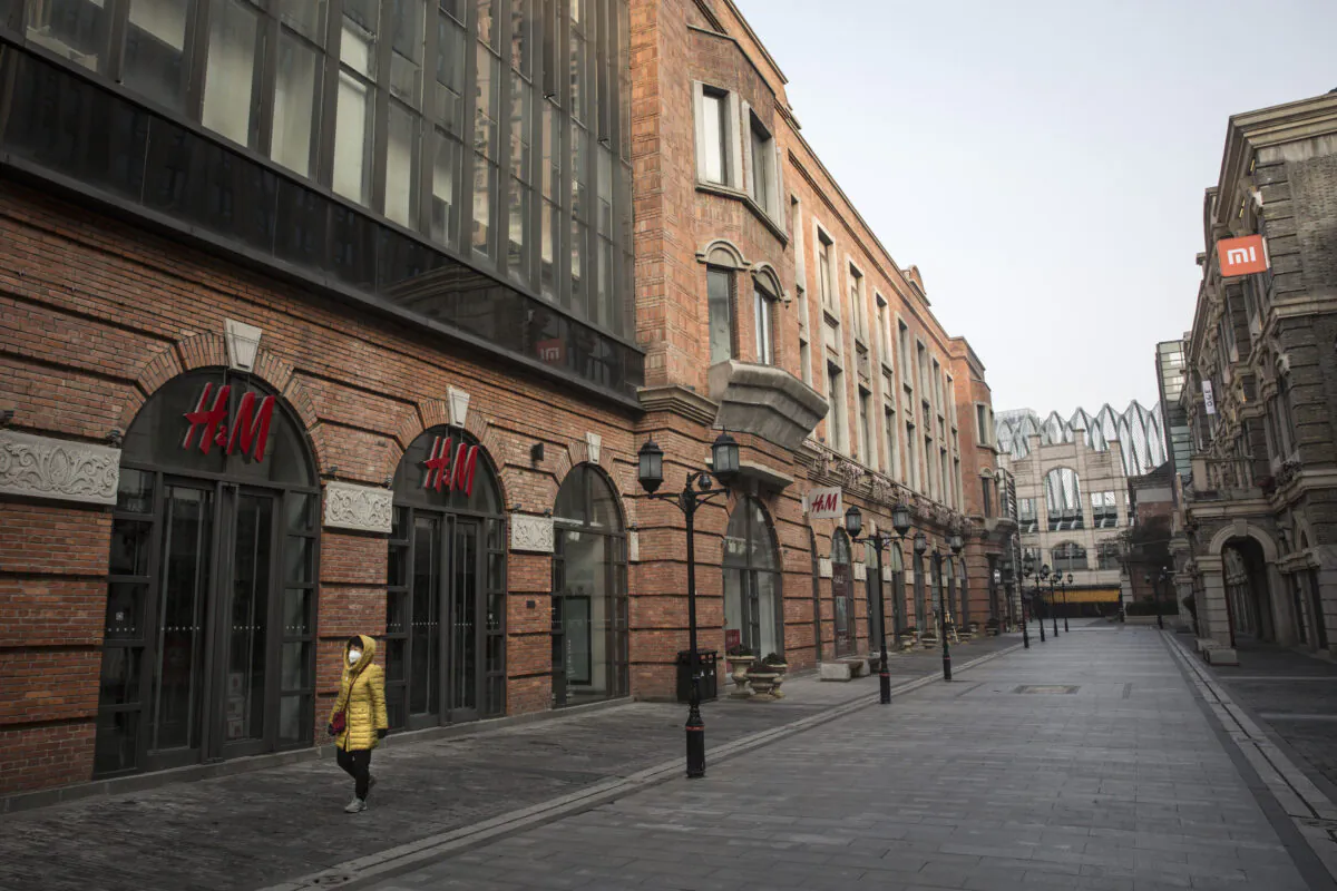 A person wears a protective mask as he walks down an empty street in Wuhan, the epicenter of the new coronavirus, on Feb. 3, 2020. (Getty Images)