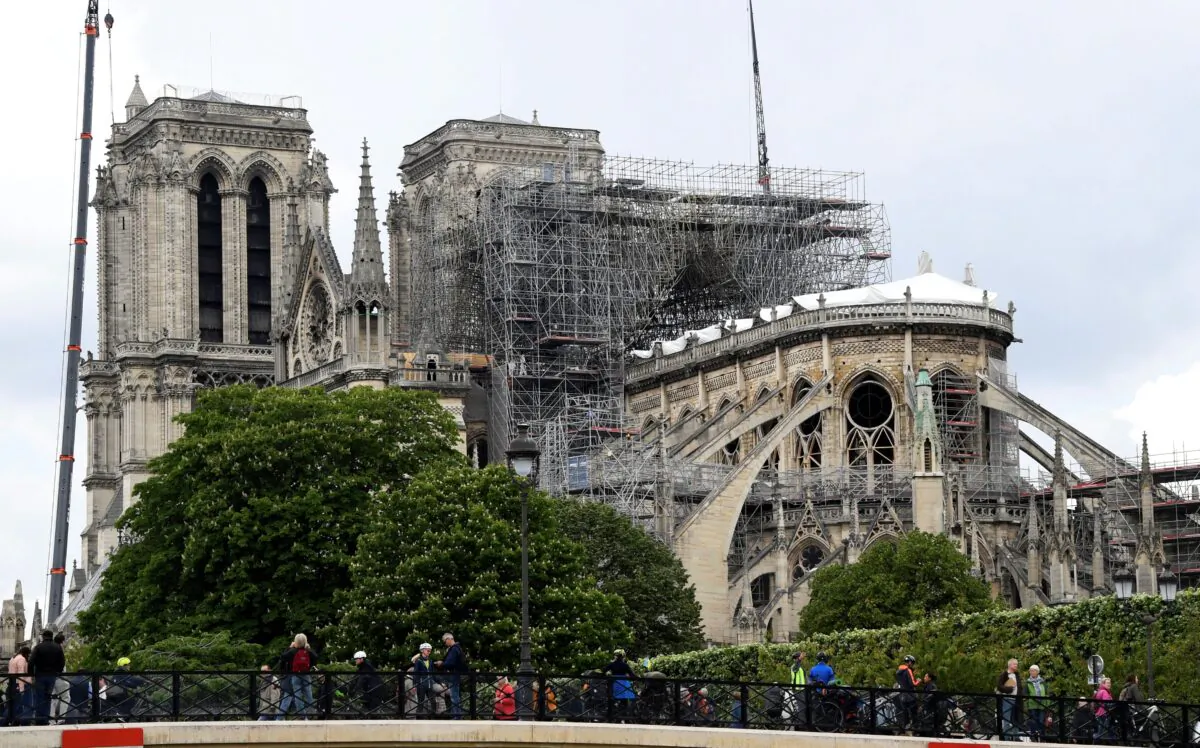 Cranes and scaffolding are seen at the Notre-Dame de Paris on May 10, 2019, as stabilization work continues in preparation for reconstruction to begin after the cathedral was badly damaged by a fire the previous month. (Bertrand Guay/AFP via Getty Images)