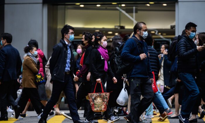 Pedestrians wear face masks as they cross a road in Hong Kong on February 3, 2020. (ANTHONY WALLACE/AFP via Getty Images)