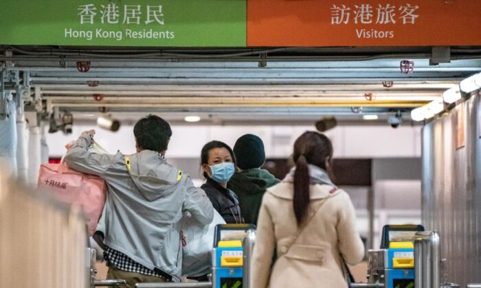 Passengers cross the gate as they arrive at the Lo Wu MTR station, where one of the border checkpoints Hong Kong government announced to be shut down, on Feb. 3, 2020. (Anthony Kwan/Getty Images)