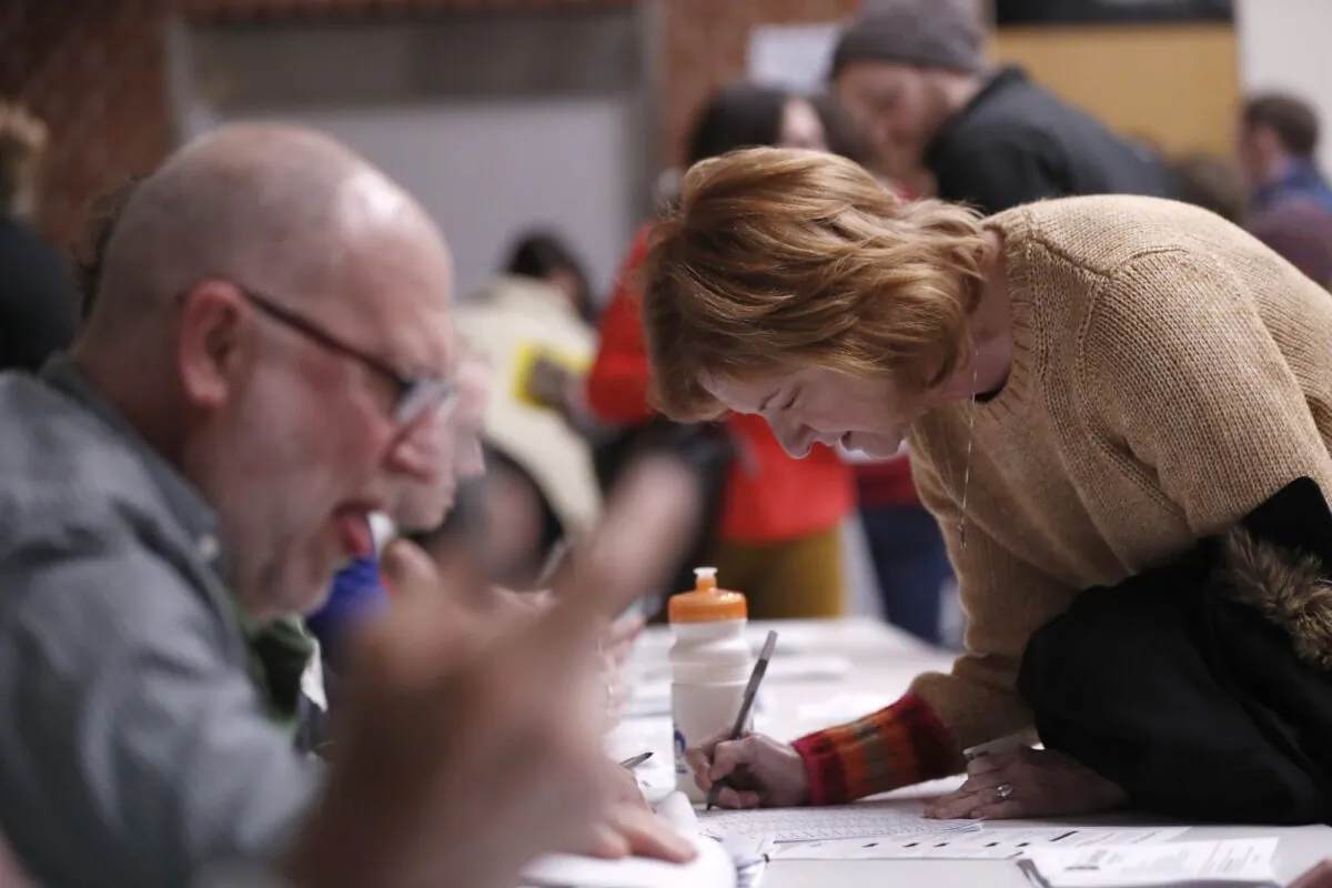 Caucus goers check in at Roosevelt Hight School, in Des Moines, Iowa, on Feb. 3, 2020. (Andrew Harnik/AP Photo)