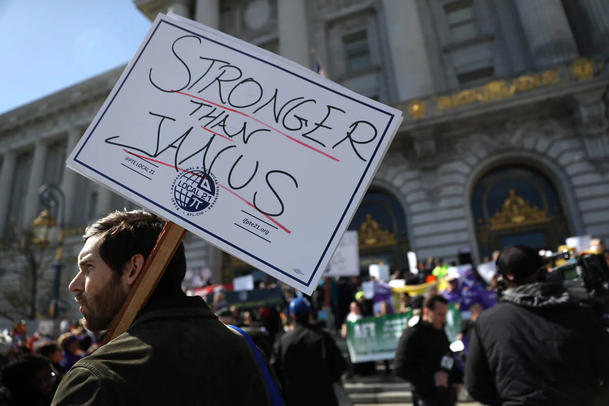 Union members hold signs during a rally outside of San Francisco City Hall on Feb. 26, 2018.  (Justin Sullivan/Getty Images)