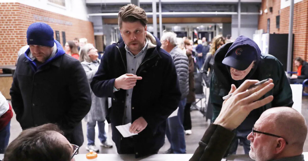 Caucus goers check in at a caucus at Roosevelt High School, in Des Moines, Iowa, on Feb. 3, 2020. (Andrew Harnik/AP)