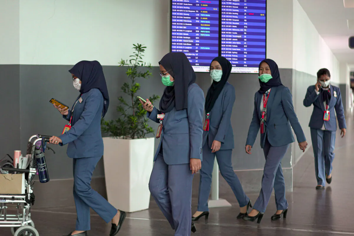Airport staff wearing masks walk through the Kuala Lumpur International Airport 2 in Malaysia on Feb. 4, 2020. (Ore Huiyang/Getty Images)