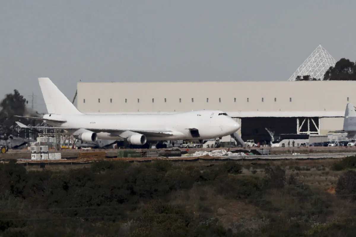 A plane carrying evacuees from the virus zone in China lands at Marine Corps Air Station Miramar in San Diego, Calif., on Feb. 5, 2020. (Gregory Bull/AP Photo)