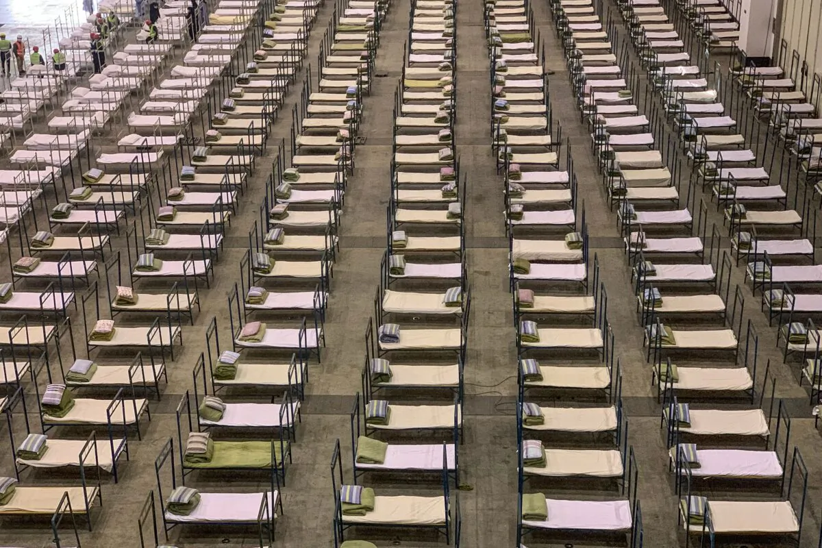 Workers set up beds at a mobile hospital in Wuhan, China, on Feb. 4, 2020. (STR/AFP via Getty Images)