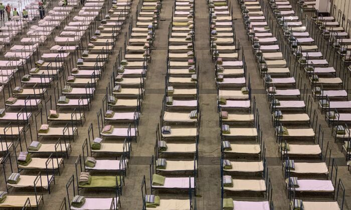 Workers set up beds at a mobile hospital in Wuhan, China, on Feb. 4, 2020. (STR/AFP via Getty Images)