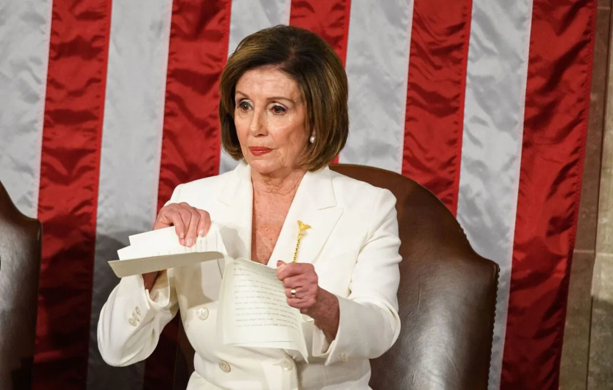 Speaker of the House of Representatives Nancy Pelosi rips a copy of President Donald Trump's speech after he delivers the State of the Union address at the US Capitol in Washington on Feb. 4, 2020. (Mandel Ngan/AFP via Getty Images)