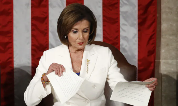 House Speaker Nancy Pelosi (D-Calif.) tears her copy of President Donald Trump's State of the Union address after he delivered it to a joint session of Congress on Capitol Hill in Washington, on Feb. 4, 2020. (Patrick Semansky/AP Photo)