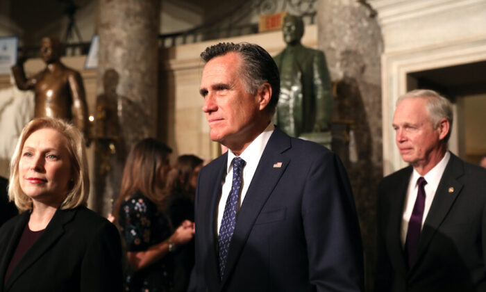 Sen. Mitt Romney (R-Utah) walks through Statuary Hall with other senators to the House Chamber for President Donald Trump’s State of the Union address in the Capitol in Washington on Feb. 4, 2020. (Charlotte Cuthbertson/The Epoch Times)