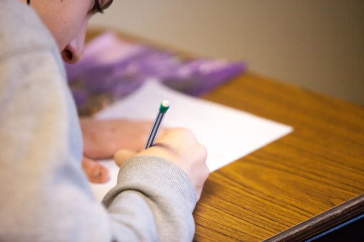 Stock photo of a student writing. (Ben Mullins/Unsplash)
