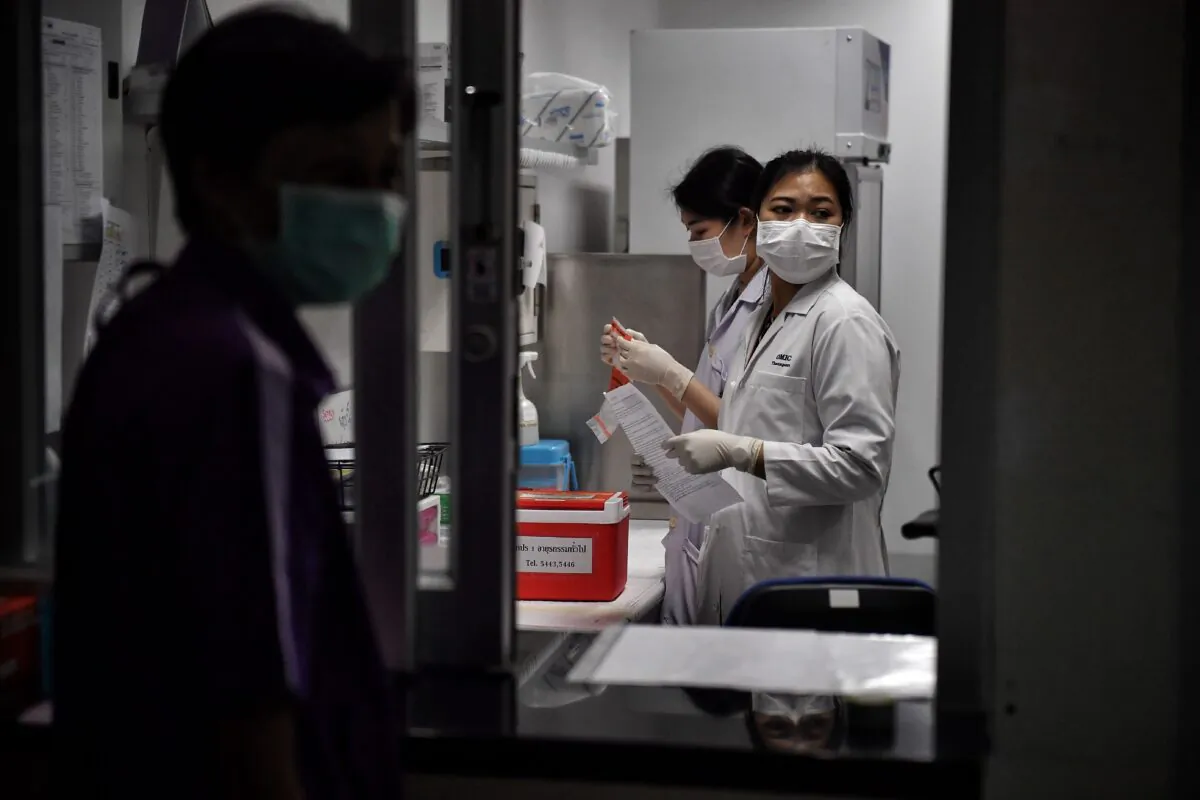 Lab technicians register samples from potential victims of the Novel Coronavirus at the Center for Emerging Infectious Diseases of Thailand at Chulalongkorn University in Bangkok on Feb. 5, 2020. (Lillian Suwanrumpha/AFP via Getty Images)