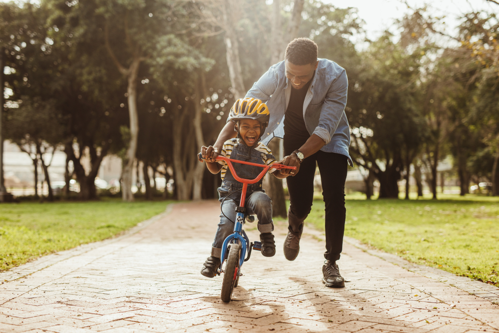 Most parents are quick to encourage their children, whether it's about learning new skills such as riding a bike, or persevering in their music practice.  (Shutterstock)